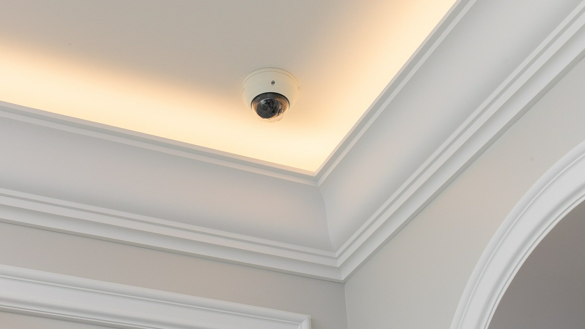 Dome surveillance video camera mounted on the ceiling of the classic design room